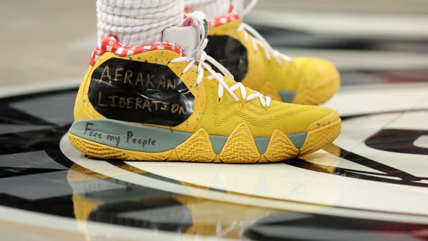 View of Kyrie Irving's yellow Nike shoes.